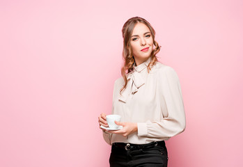 Wall Mural - The serious frustrated young beautiful business woman on pink background