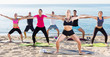 © JackF - People practicing yoga on beach