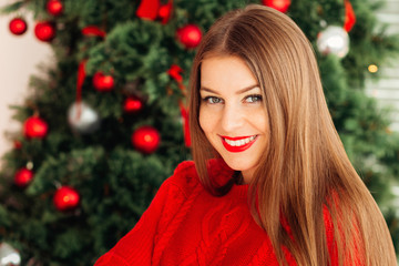 Romantic long-haired Hipster Girl in Knitted red Sweater near ch