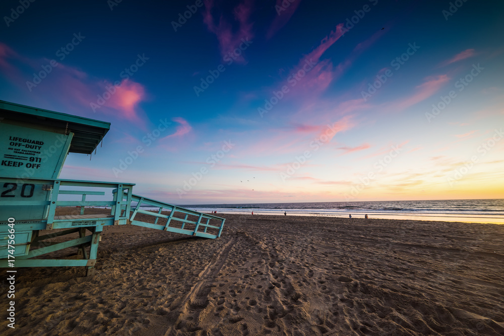 Colorful sky over a lifeguard hut