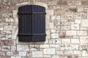 Shuttered window in a castle wall