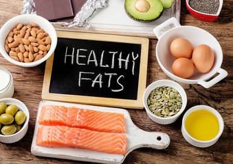 Wall Mural - Selection of healthy fat sources on wooden background