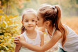 © svetabezu - Childhood, family, friendship and people concept - two happy kids sisters hugging outdoors.