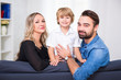 © Di Studio - happy family portrait - young couple and cute little son sitting at home