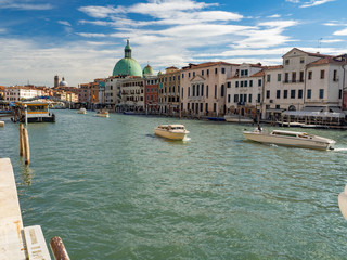 Beautiful view of traditional Gondola on Canal Grande in the background on a sunny day in Venice, Italy. Summer and blue sky