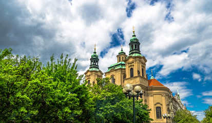 Poster - Baroque church of St. Nicholas in Malá Strana quarter in the romantic Prague under blue sky. Panoramic of the old city of the hundred towers on a summer day in the capital of the Czech Republic.