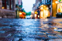 Macro Closeup Of Colorful, Vibrant And Cobblestone Street At Night After Rain With Reflection Of Lights