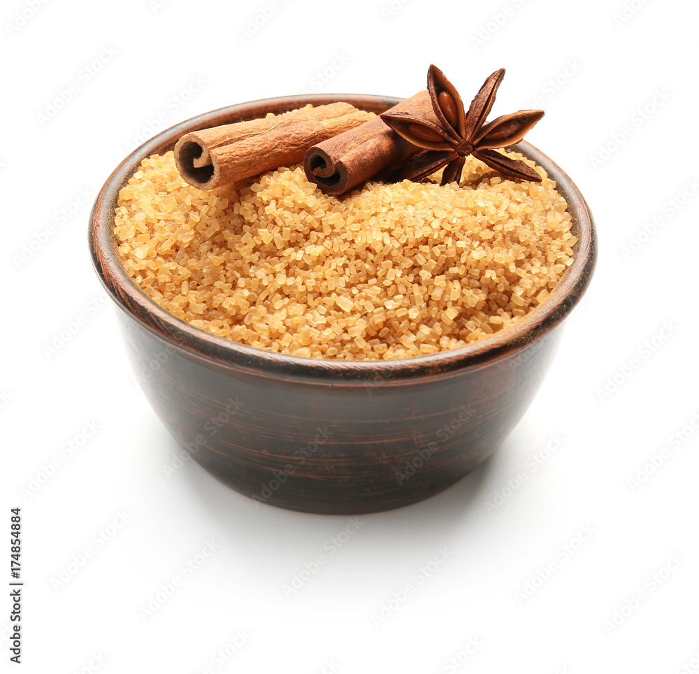 Bowl with cinnamon sugar and sticks on white background