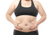 © Africa Studio - Woman touching fat on her belly against white background. Weight loss concept
