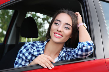 Wall Mural - Beautiful young woman in car