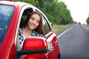 Wall Mural - Young woman driving car