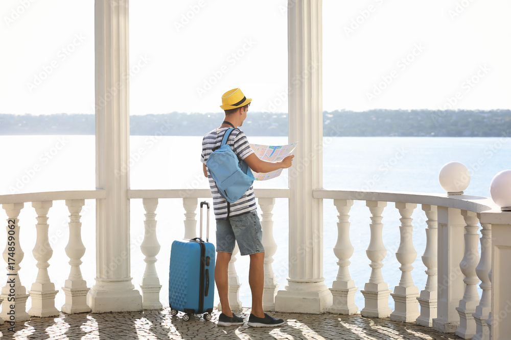 Young man with map outdoors