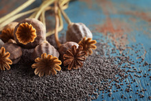 Dried Poppy Heads And Seeds On Table, Closeup