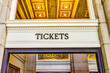 Transportation tickets sign inside building with golden lights