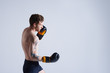 © Anatoliy Karlyuk - Hardworking young unshaven young European boxer exercising in studio, challening himself, having concentrated look, focused on boxing technique to improve efficiency, preparing for boxing match