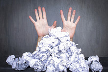 Too Much Work Or Lack Of Inspiration Concept, Pile Of Crumpled Paper And Woman`s Hands Behind It, Black Background.