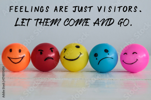 Feelings are visitors, let them come and go quote on emotions balls background ,Happy Smiley face yellow ball , orange and pink. Sadness ball in blue and madness ball in red. Self made hand draw balls