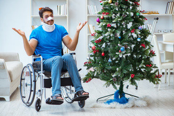 Wall Mural - Injured disabled man celebrating christmas at home