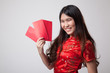 © halfbottle - Asian girl in chinese cheongsam dress with red envelope