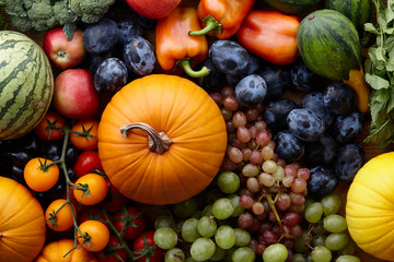 Autumn harvest concept. Seasonal fruits and vegetables on a wooden table, top view