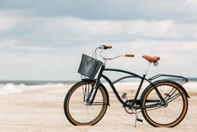 Pretty Bicycle Parked On Beach. Retro Bike Near The Sea