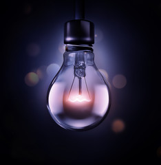 Canvas Print - glowing light bulb on a dark