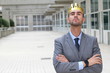 Arrogant businessman with a crown in office space