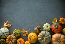 Thanksgiving Day Or Seasonal Autumnal Background With Pumpkins And Fallen Leaves