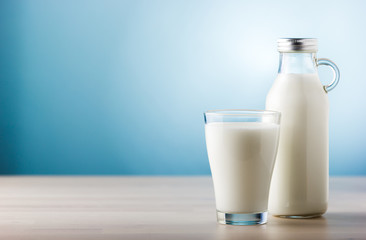 Jar and glass of milk, front view