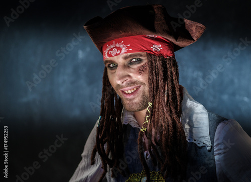 Portrait of a young man in a pirate costume.