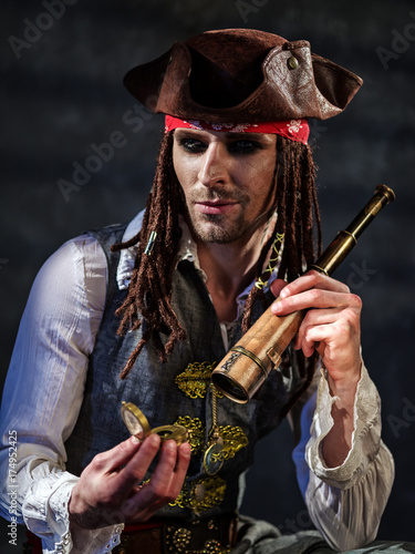 Portrait of a young man in a pirate costume.
