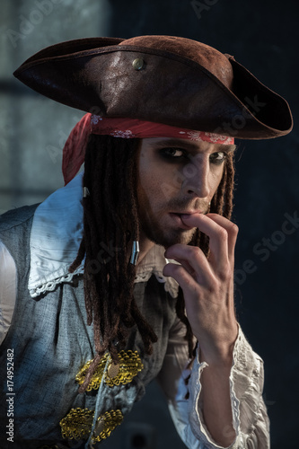 Portrait of a young man in a pirate costume.