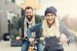 © Kalim - Young couple riding bikes and having fun in the city