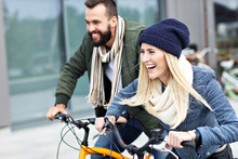 Young Couple Riding Bikes And Having Fun In The City