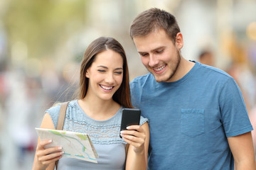 Wall Mural - Couple of tourists searching location on line on the street