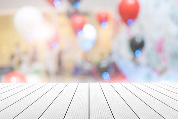 Empty wooden table with party in wedding background blurred.