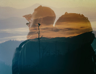 Photo of stylish bearded traveler looking into the distance. Double exposure, beautiful mountain landscape background. Made in vintage style.