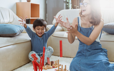 Wall Mural - happy family playing at home,Mom and baby are happiness coexistence,happy family concept and Creating activities to strengthen skills for children.