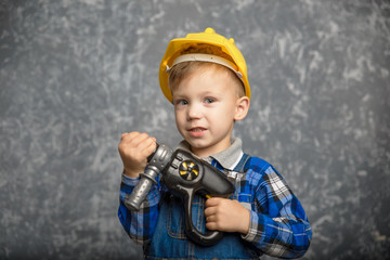 Wall Mural - Boy in hard hat with drill, screwdriver in hand