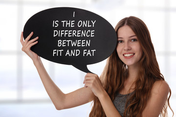 Wall Mural - Young beautiful woman holding Speech Bubble with message I is the only difference between fit and fat. Female dieting and Fitness motivation