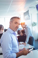 Wall Mural - Portrait of businessman using mobile phone