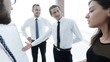 © ASDF - senior Manager of pointing business team on a blank flipchart.