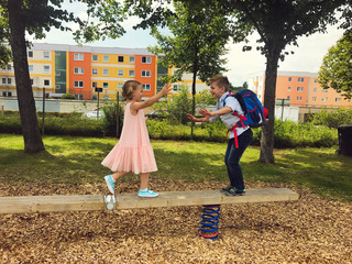 Wall Mural - Cute brother and sister playing at playground