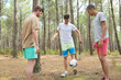 © auremar - cheerful positive brothers playing soccer with son outdoors