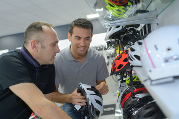 client choosing helmet in motorcycle store