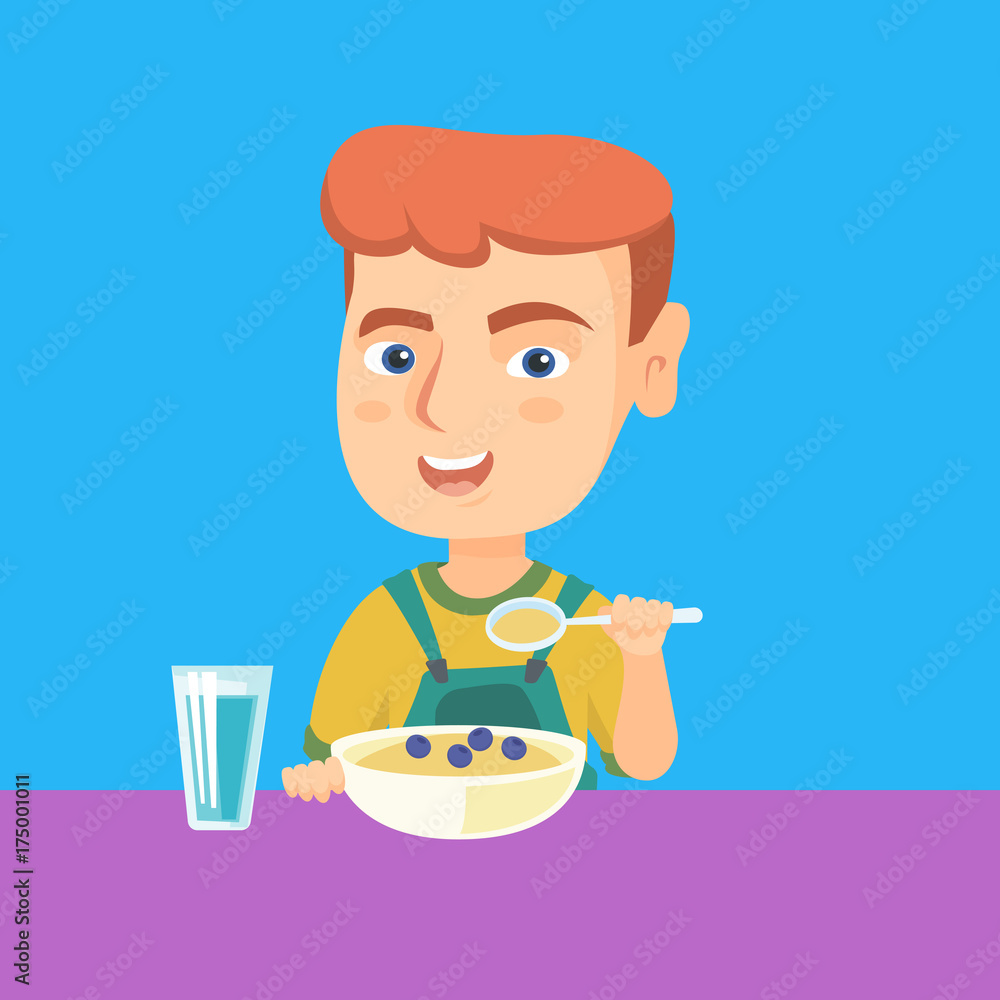 Happy caucasian boy sitting at the table with bowl of porridge with ...