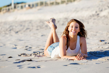 Wall Mural - Young woman relaxing on the beach