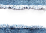 Fototapeta Dziecięca - Edge frame of blue denim jeans ripped over white background.