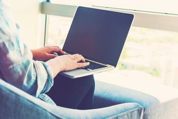 Wall Mural - Woman on a laptop in a modern brightly lit room