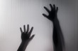 © FrameAngel - Halloween hands behind transparent glass blur background as silhouette